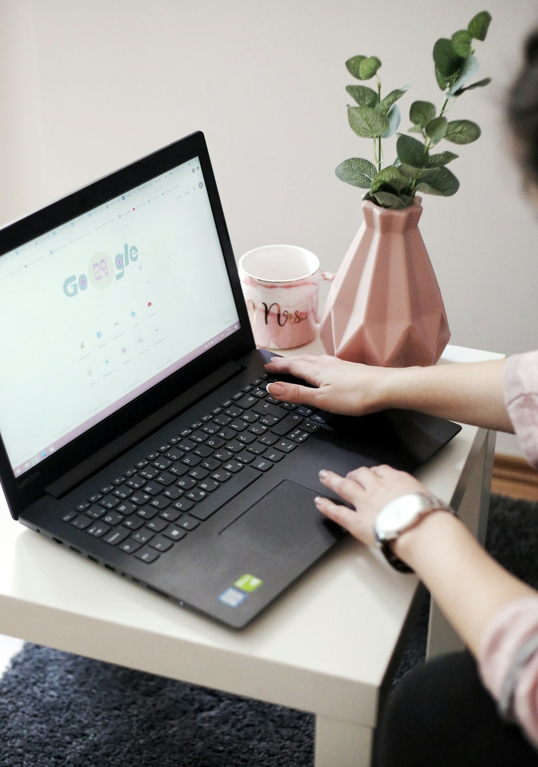 a-person-holding-a-cup-and-a-laptop-kiq3m4vyytk